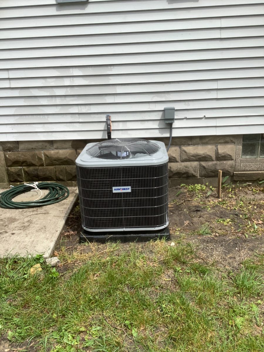 Airquest central air conditioner installed outside a home