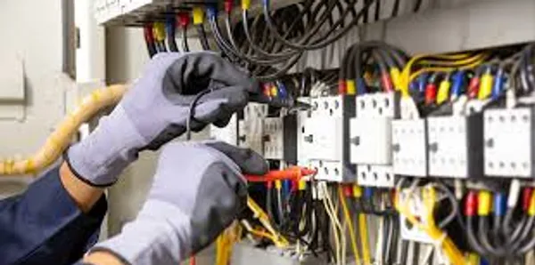 Electrician working inside a residential breaker panel