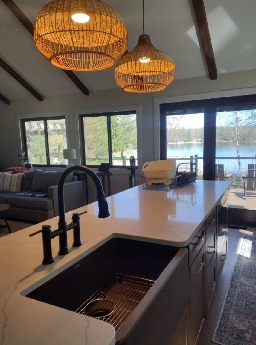 A lakeside kitchen with a farmhouse sink and black fixtures