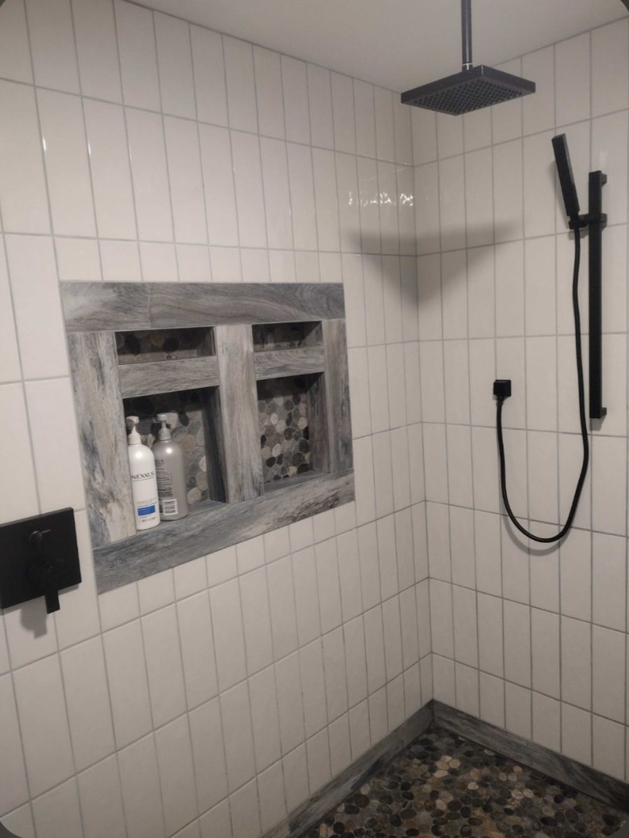 Tiled walk-in shower with a niche